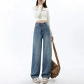 Woman wearing retro blue high-waist wide leg denim jeans with a relaxed fit.