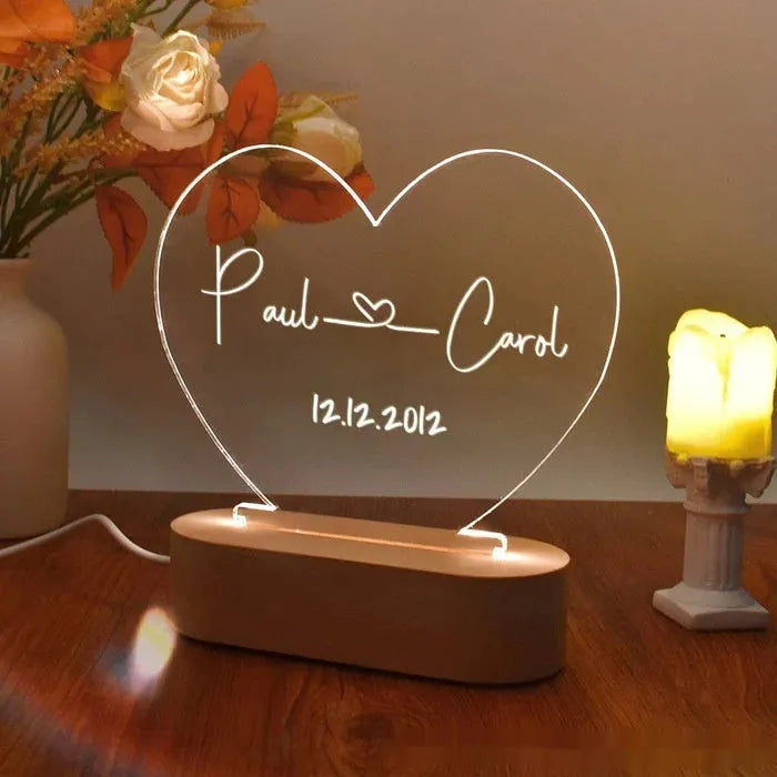 Custom engraved acrylic night light with names and date, illuminated by an LED base.