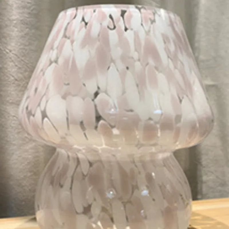 Flame mushroom pink and white glass mushroom table lamp with USB power and three-color light on a bedside table