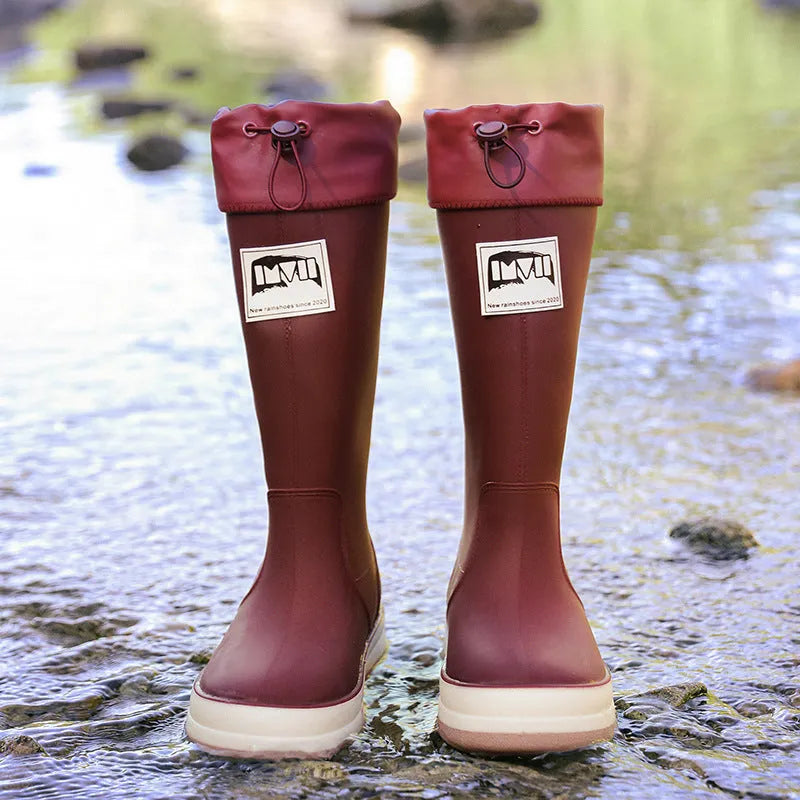 Solid colour high tube PVC rain boot in beige, shown on a white background.