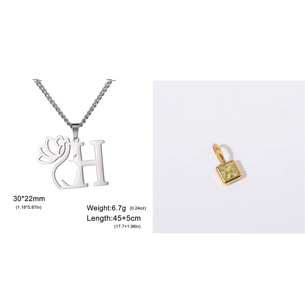 Gold electroplated stainless steel necklace with a cross chain and a letter 'A' pendant on a white background.