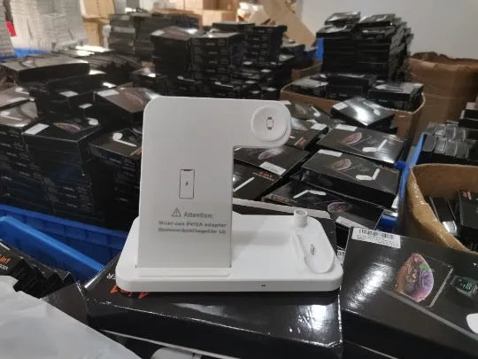 Folding 4-in-1 wireless charger in space grey, charging an iPhone, Apple Watch, and Apple Pencil.