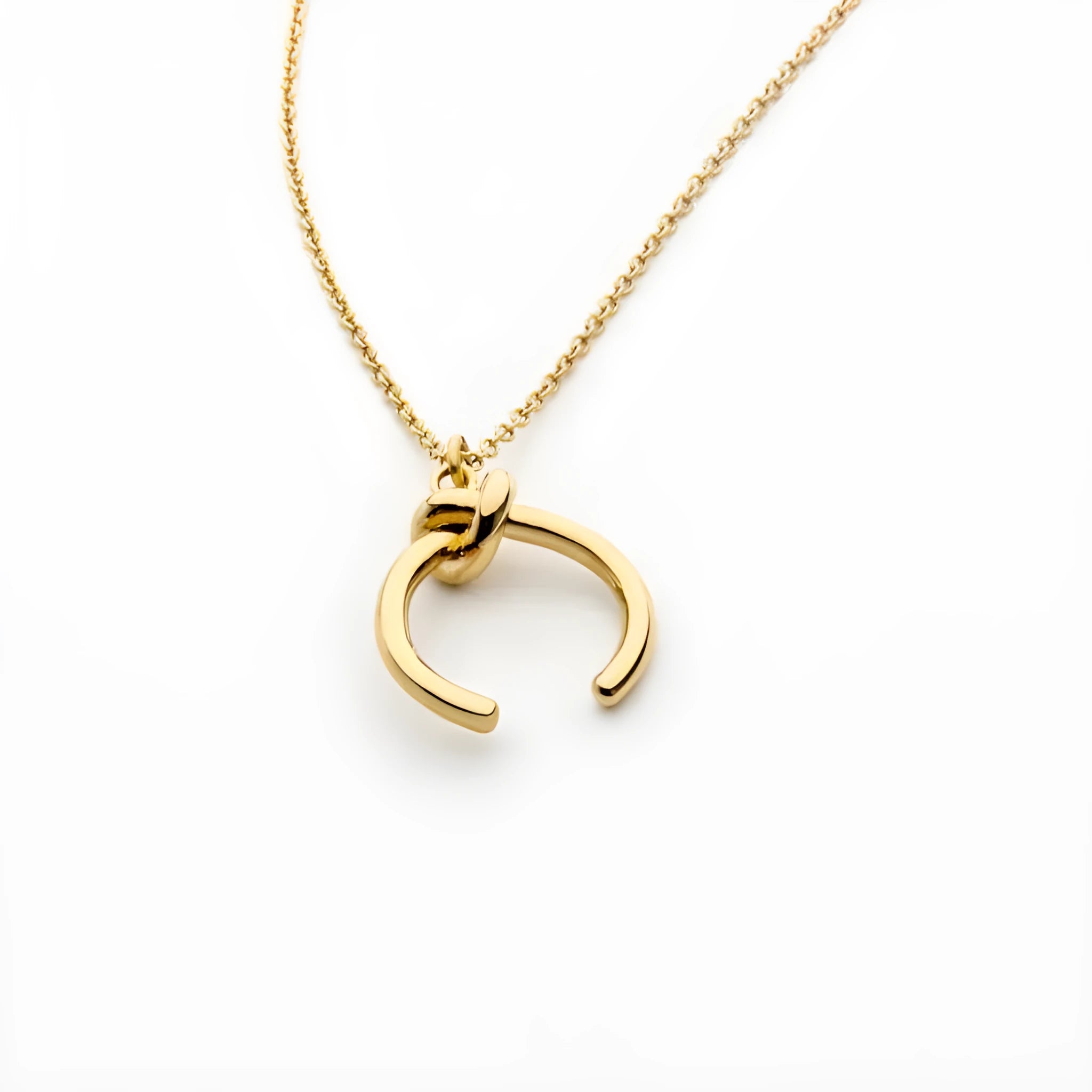 Gold geometric pendant necklace on a cross chain, shown at an adjustable length.