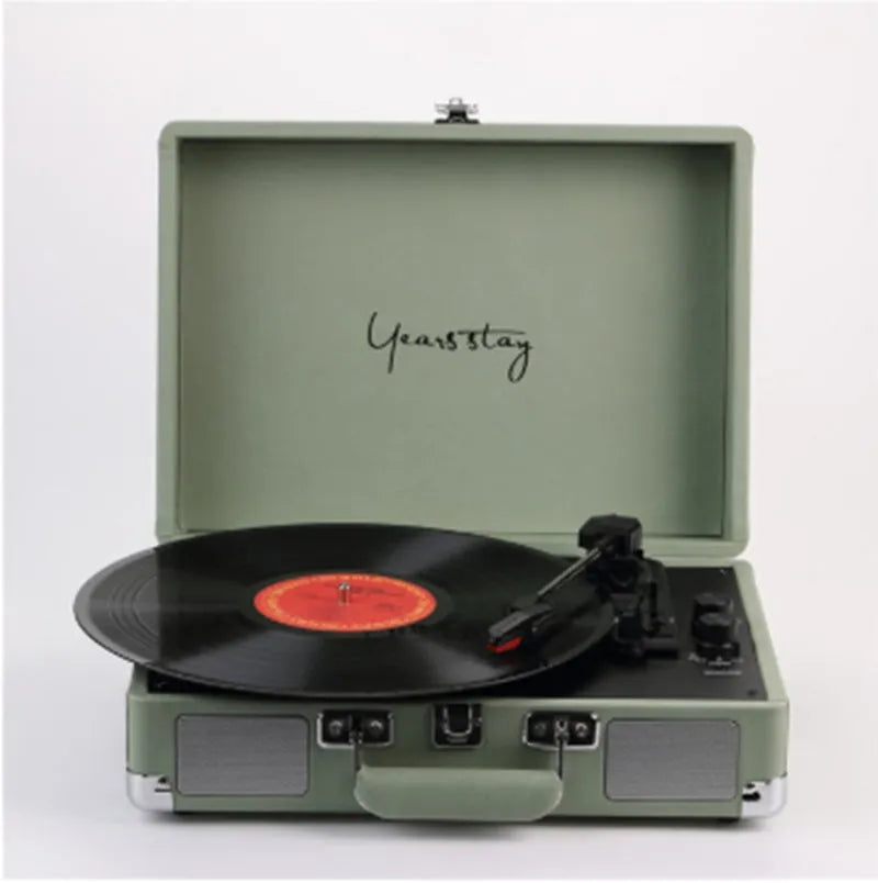 Portable Bluetooth phonograph turntable in a leather case, showing colour options.