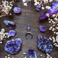 Silver moon-shaped pendant necklace with purple natural crystal centrepiece on alloy chain