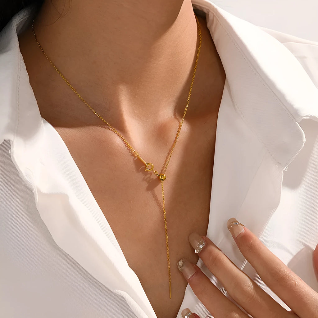Stainless steel necklace with a U-shaped pendant on a chain, shown in steel, gold, and rose gold colour options.