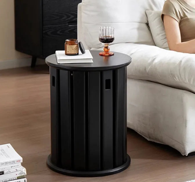 Set of four stackable iron dining stools with circular seats in a modern design, shown nested together.