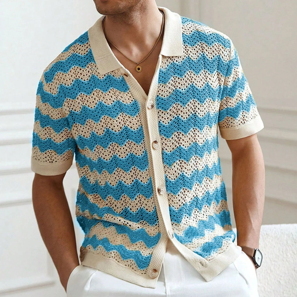 Man wearing a blue short-sleeve sweater with a textured jacquard knit pattern.