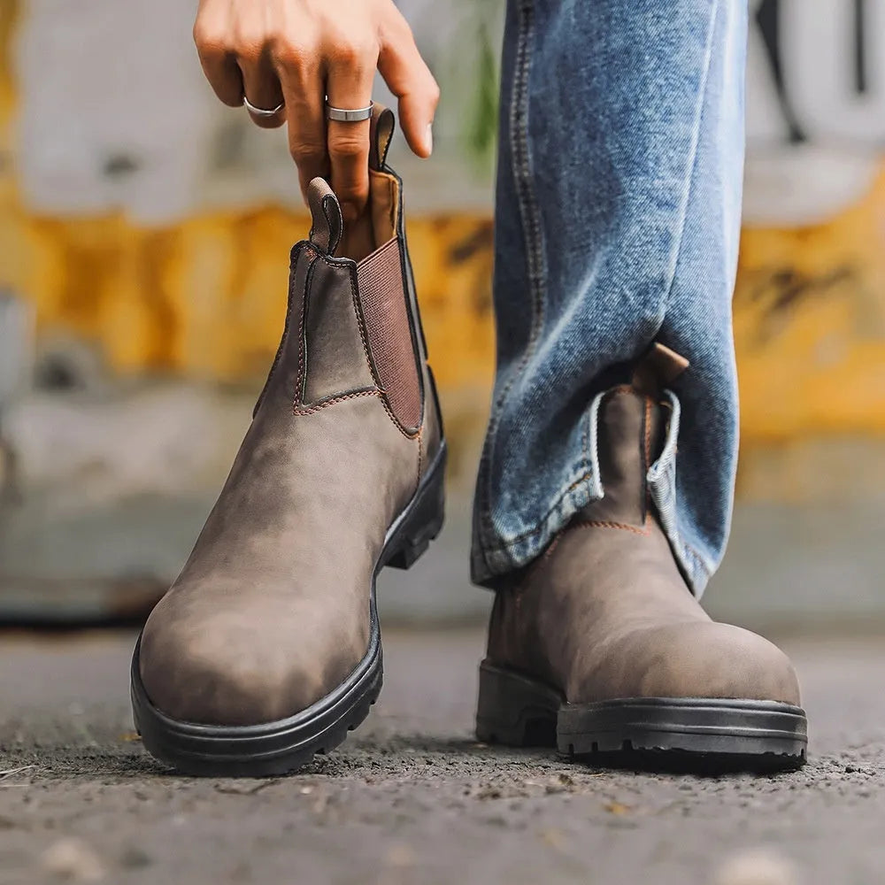 Vintage brown Chelsea boot with frosted PU upper, round toe, and mid-calf height on a wooden surface.