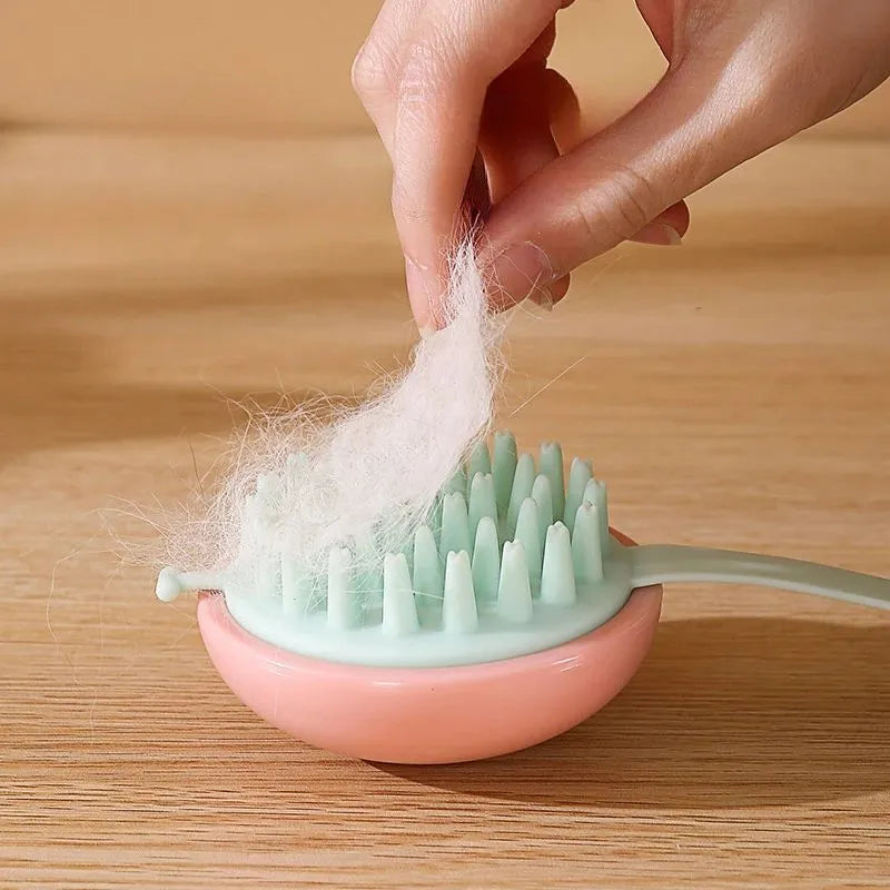 Blue silicone pet bathing brush with soft bristles for washing and massaging cats or dogs.