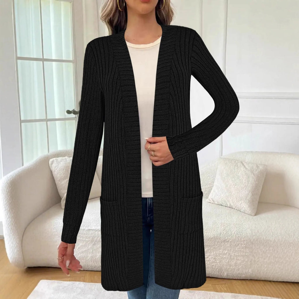 Long sleeve loose fit knitted cardigan jacket in black, shown on a hanger.