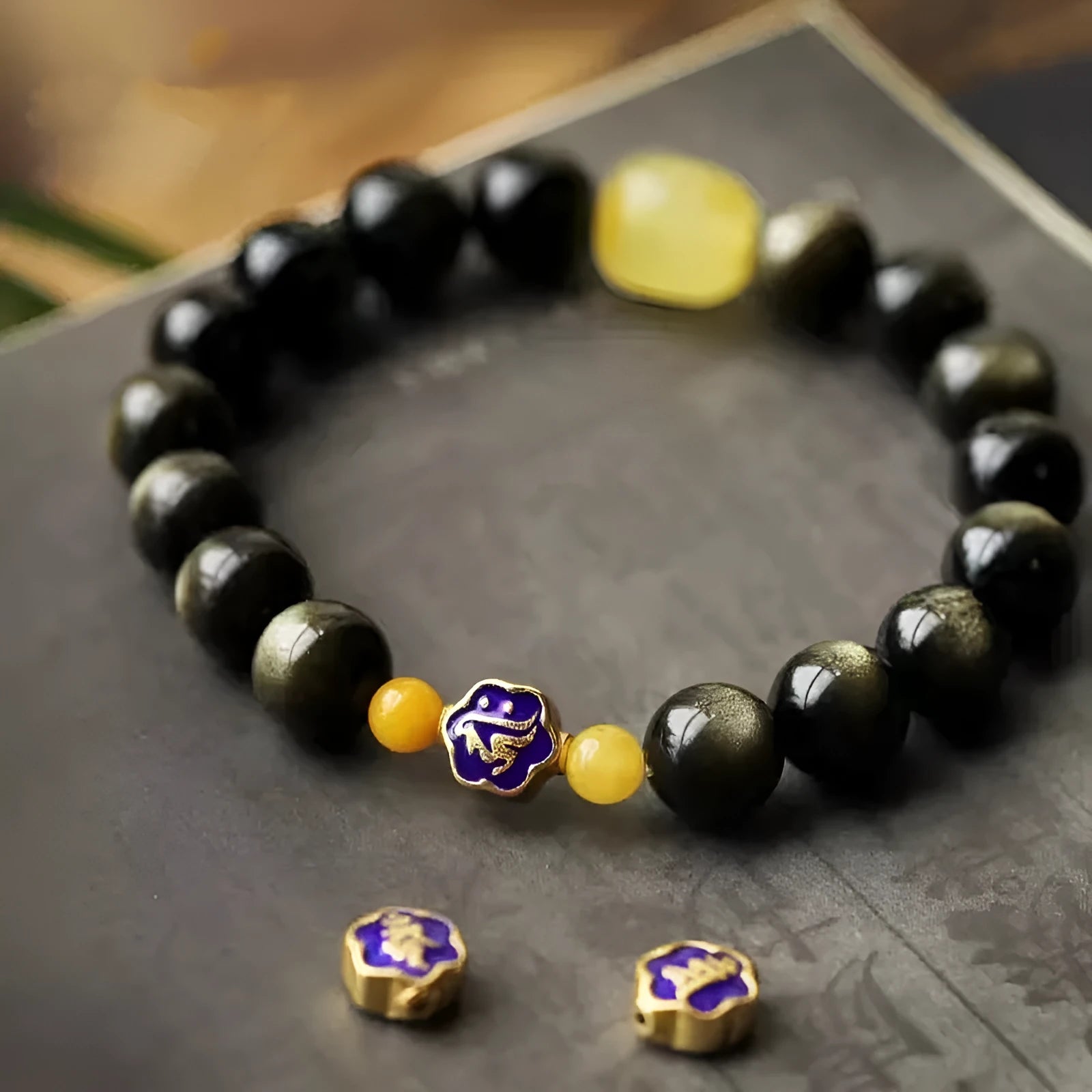 Golden obsidian ethnic bracelet with zodiac symbols on geometric 10mm stones