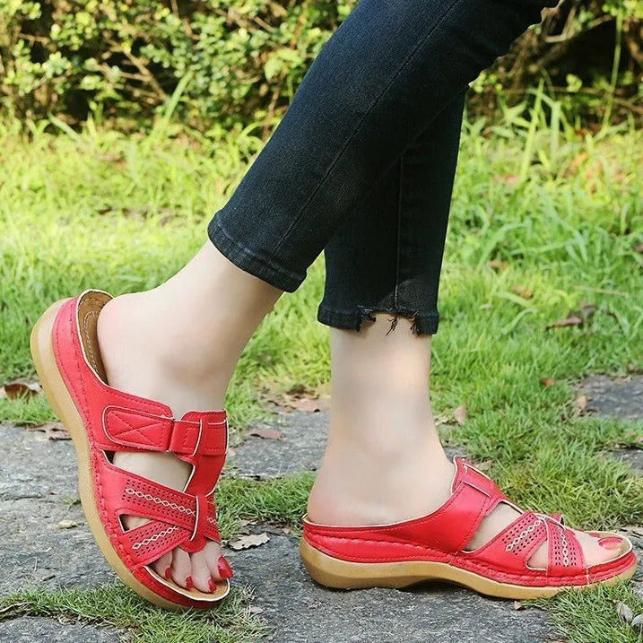 Women's red peep toe wedge sandals with Velcro strap on a fish mouth sole.
