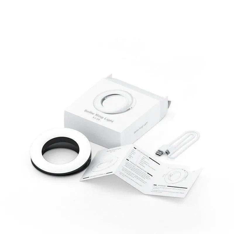 Black LED selfie ring light for mobile phones with USB cable, shown next to a smartphone.