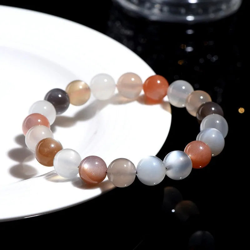 Unisex moonstone bracelet with colourful moonlight 8mm beads on a white background.