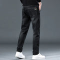 Men's slim straight casual trousers in blue grey and black colours, showing mid-waist and zipper fly detail.