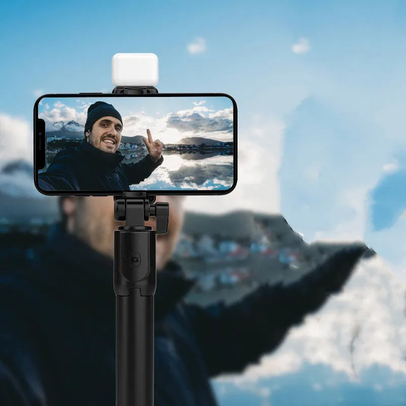 Aluminium alloy Bluetooth selfie stick with integrated tripod base and 360-degree rotating phone holder in black colour.