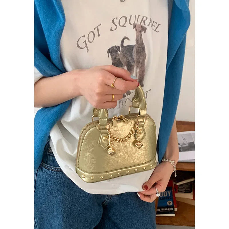 Champagne-gold PU shell bag with stitched seams, shown in shoulder mode against a neutral background