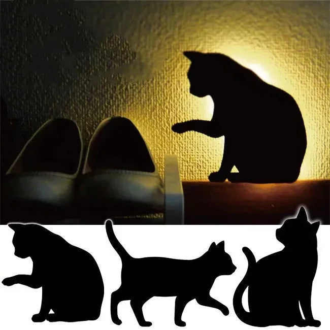 Black cartoon cat shaped LED night light with sound sensor for wall mounting.