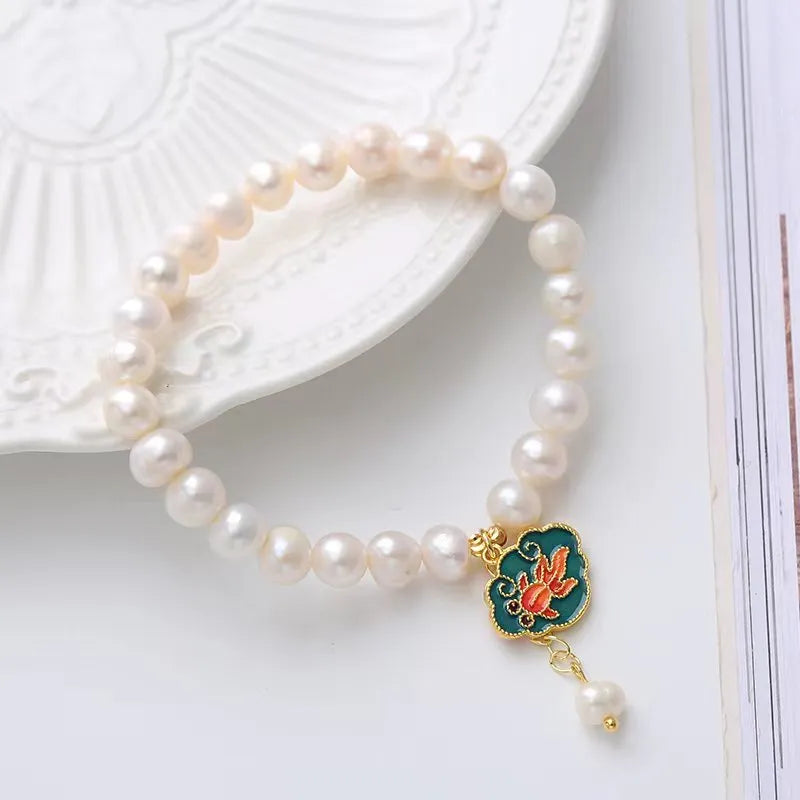 White freshwater pearl bracelet with goldfish pendant and lotus design in vintage baroque style