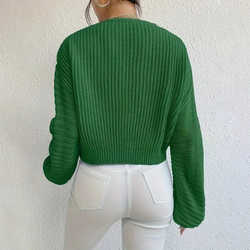 A woman's solid colour long sleeve pullover jumper in a loose, casual fit.