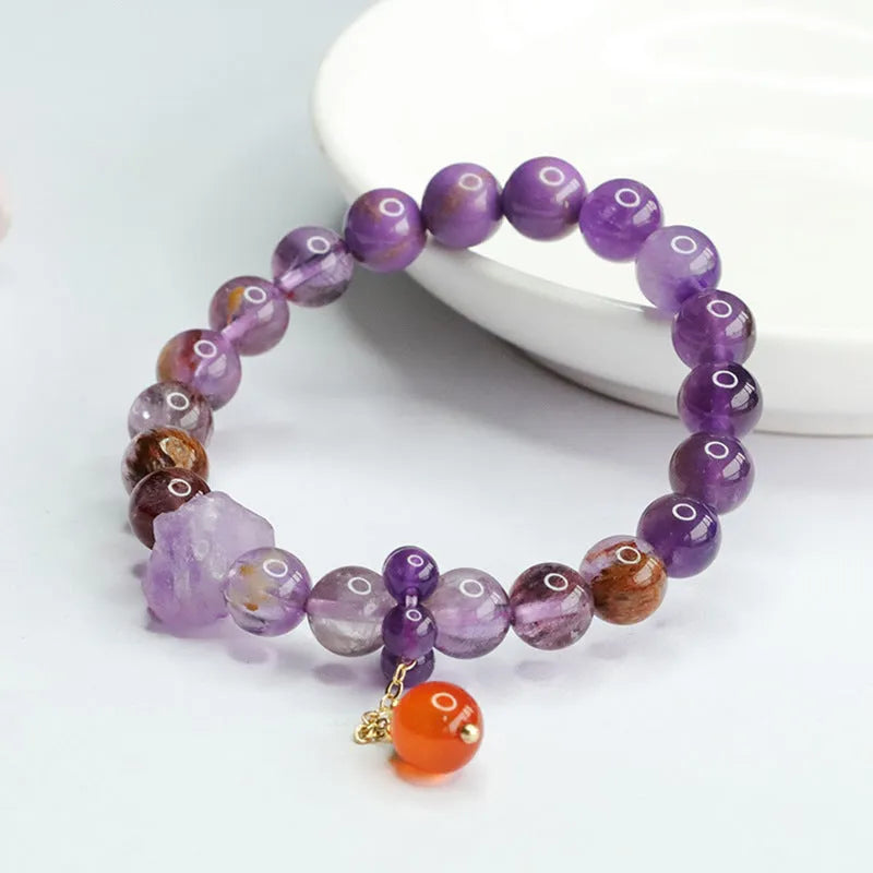 Nine purple amethyst and red agate crystal bracelet showing 8mm beads and Mori style design