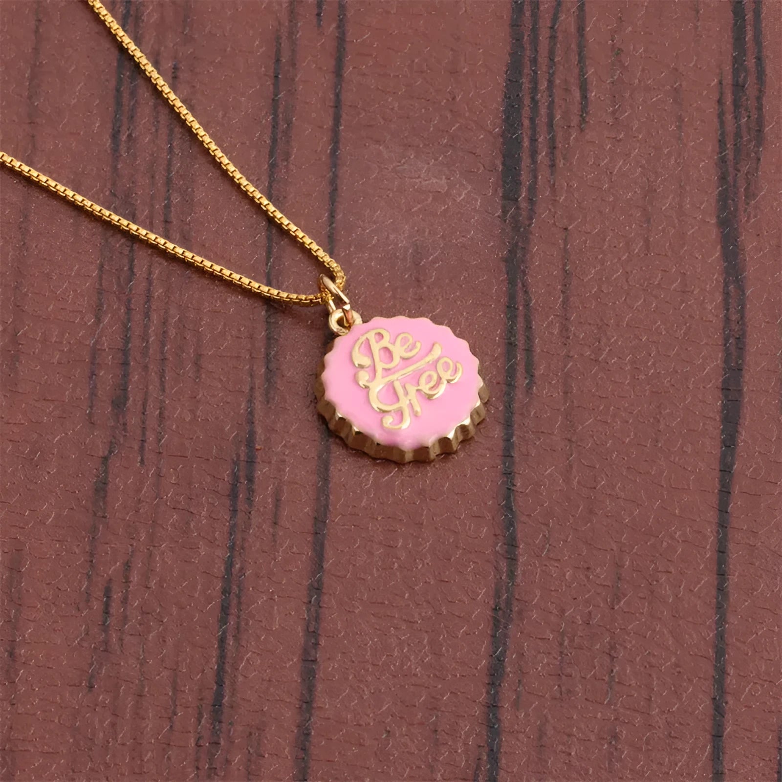 Copper Be Free bottle cap pendant necklace with a gold-plated finish on a 40cm box chain.