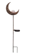LED solar flame light with warm white glow, iron construction, and glass globe in an outdoor garden setting