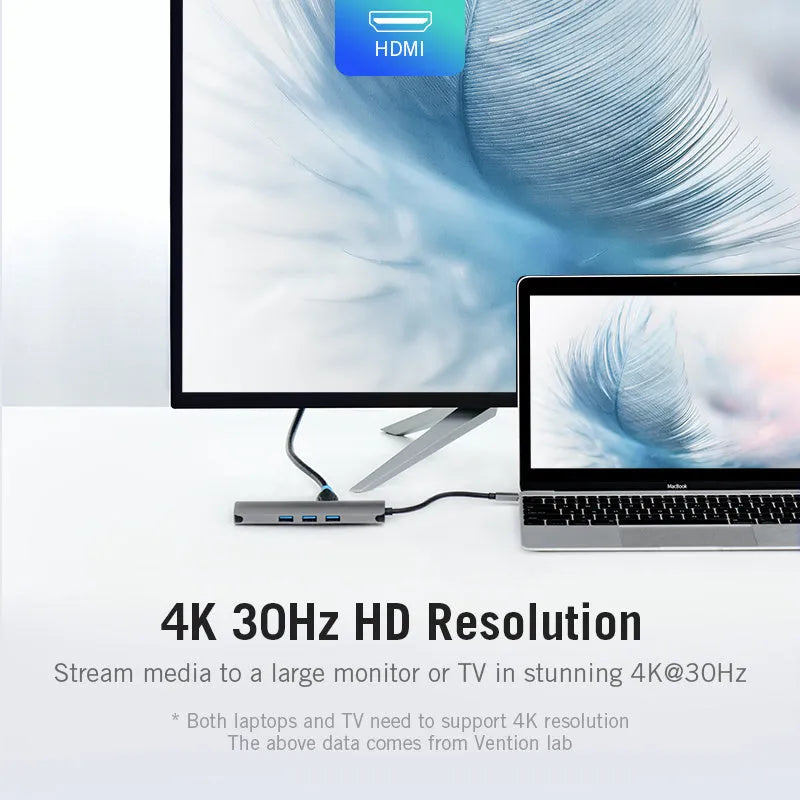 Deep grey USB-C multiport hub showing HDMI, USB ports, Ethernet, and card slots on a compact aluminium body.