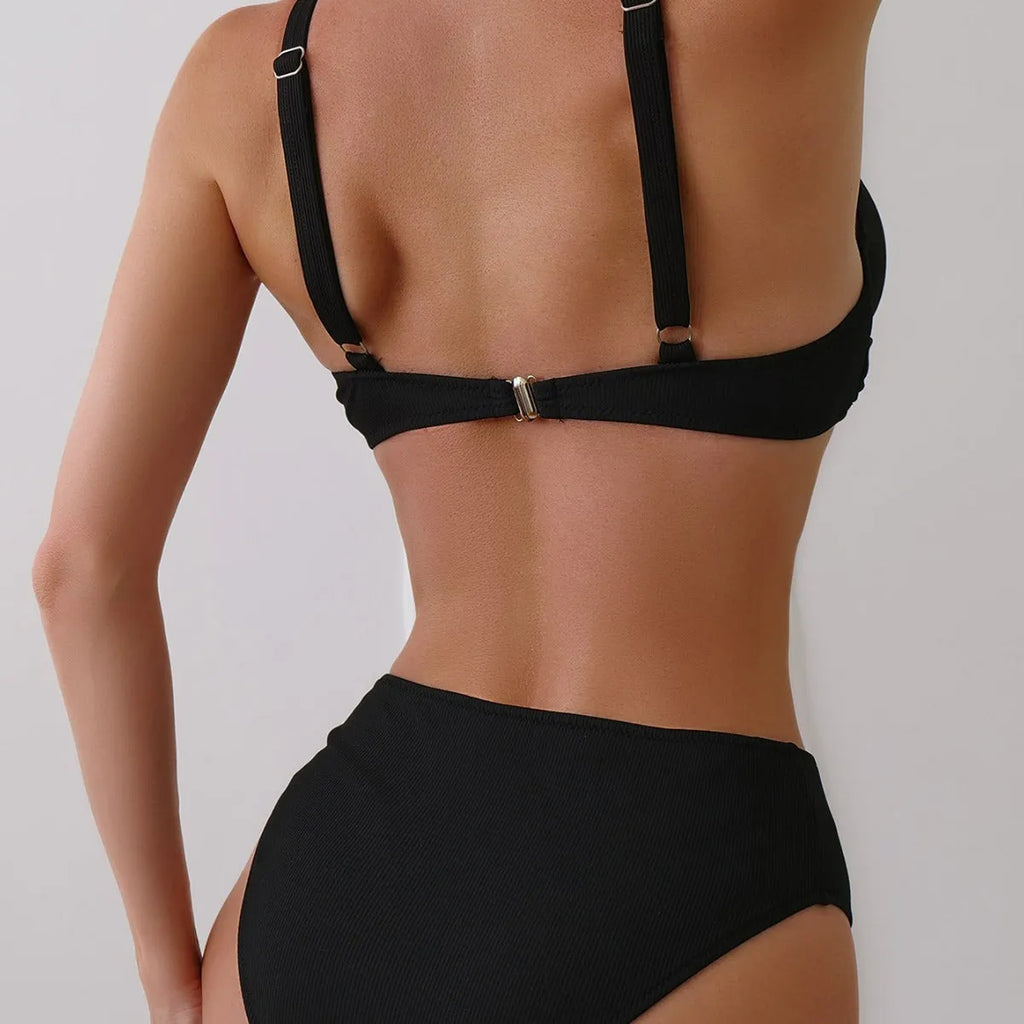 Women's black rib fabric two-piece bikini set with briefs-style bottoms on a mannequin.