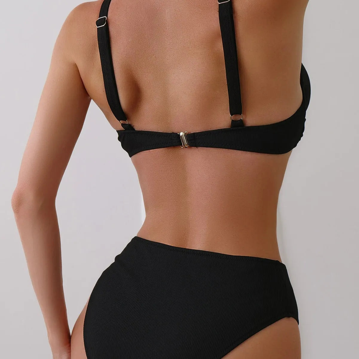 Women's black rib fabric two-piece bikini set with briefs-style bottoms on a mannequin.