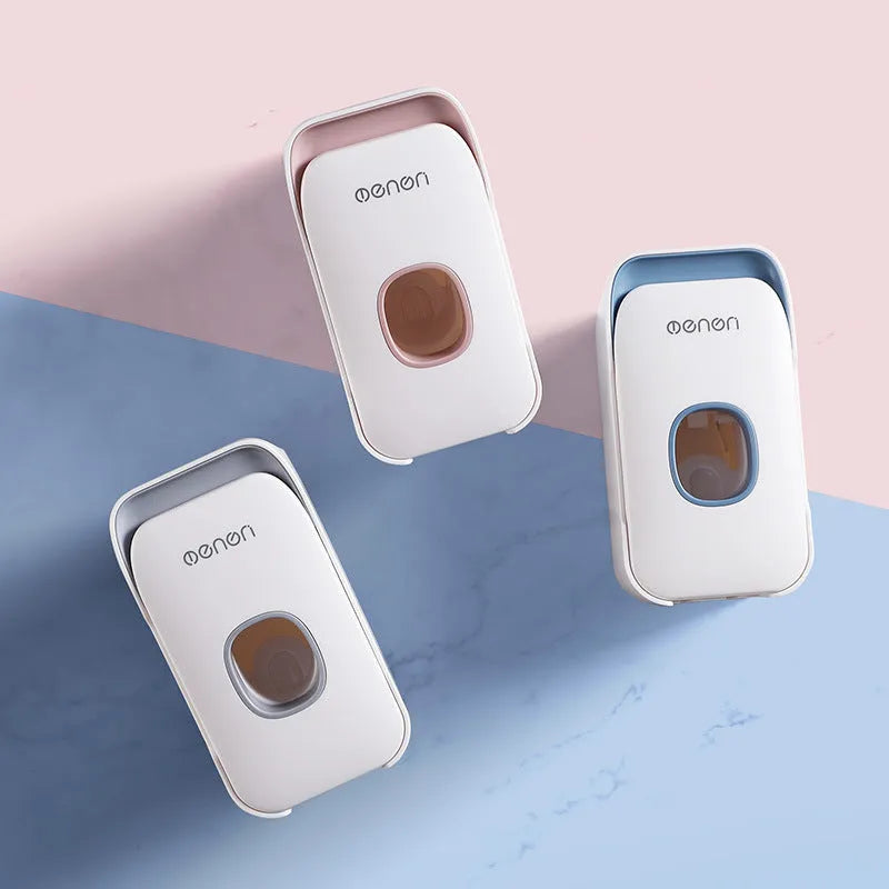 Blue, grey, and pink automatic toothpaste dispenser made of ABS plastic for wall mounting