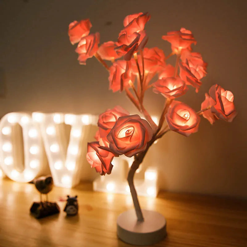 White and red rose flower shaped USB battery LED table lamp with warm white light on a table