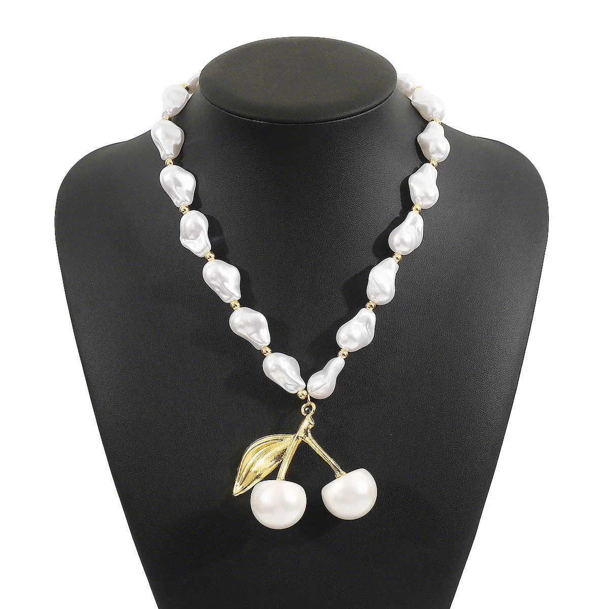 Gold irregular cherry fruit pendant on an adjustable imitation pearl chain necklace for women.