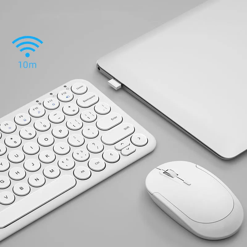Mute white ultra-thin wireless keyboard and mouse with small USB receiver on a wooden desk.