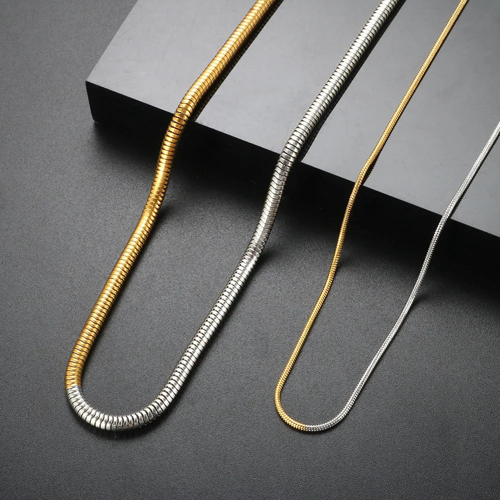 Close-up of a women's golden snake bone chain necklace with 3mm thick geometric stainless steel links.