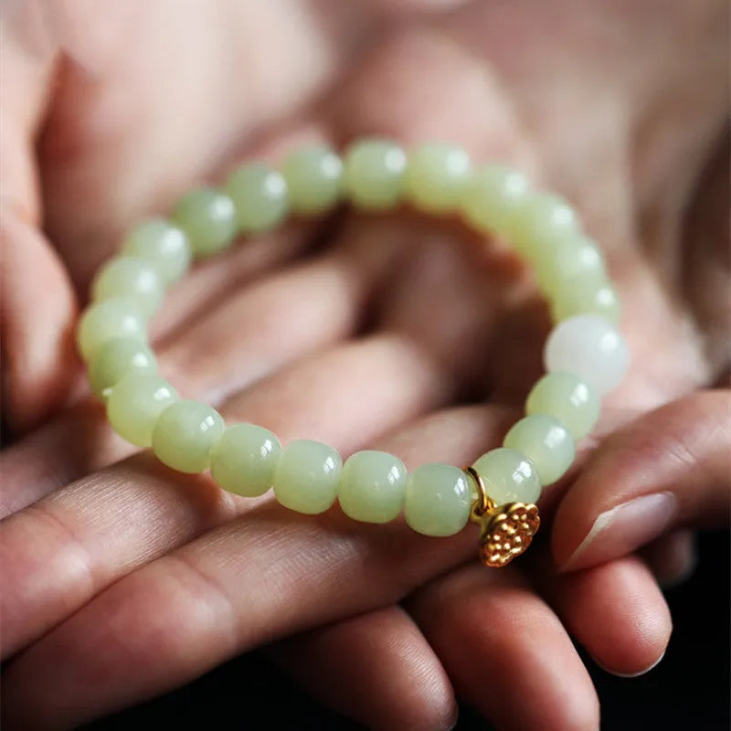 Green Hetian jade bracelet with vintage ethnic style beads on a string.