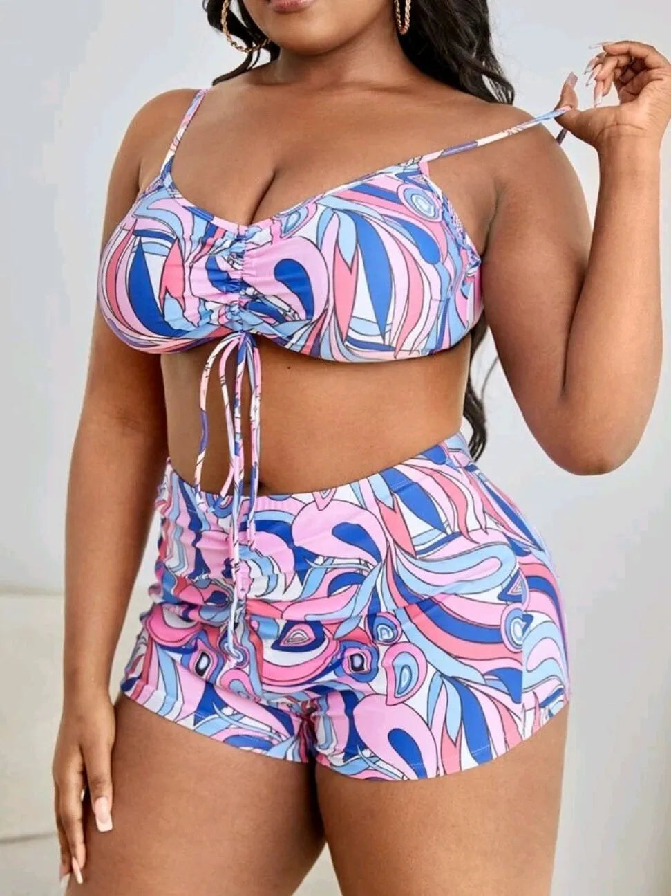Women's floral print swimsuit three-piece set showing bra, shorts, and matching cardigan