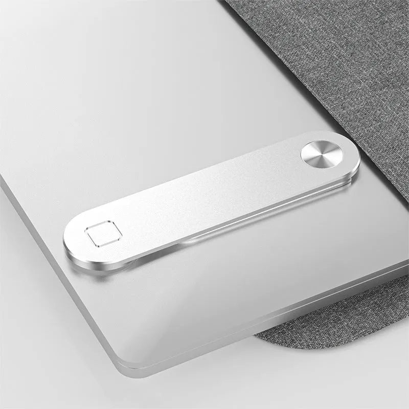Black aluminium laptop phone holder with magnetic mount attached to side of silver laptop