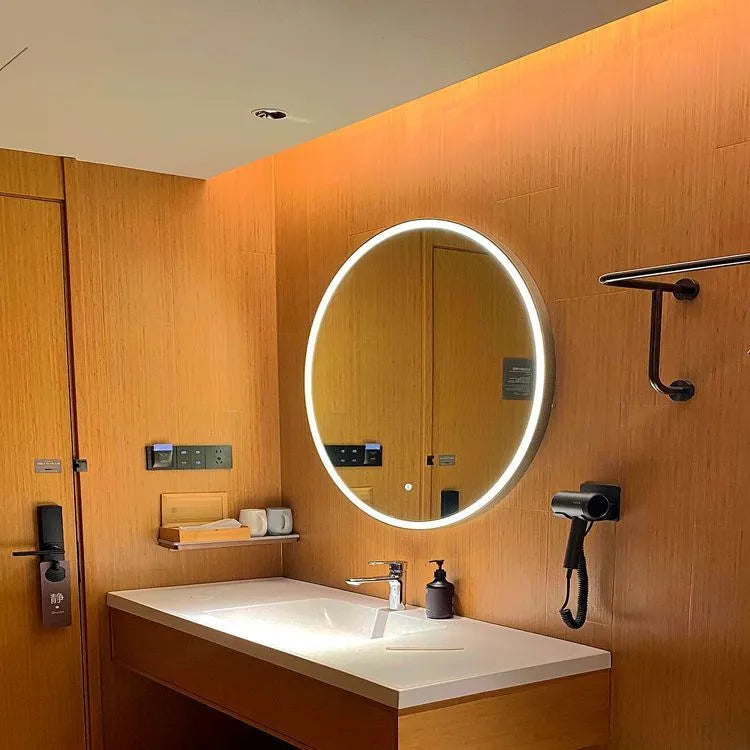 Round black aluminum frame smart bathroom mirror with integrated LED lighting on a wall.