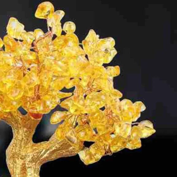 Citrine coloured small water turtle money tree resin ornament on a white background.