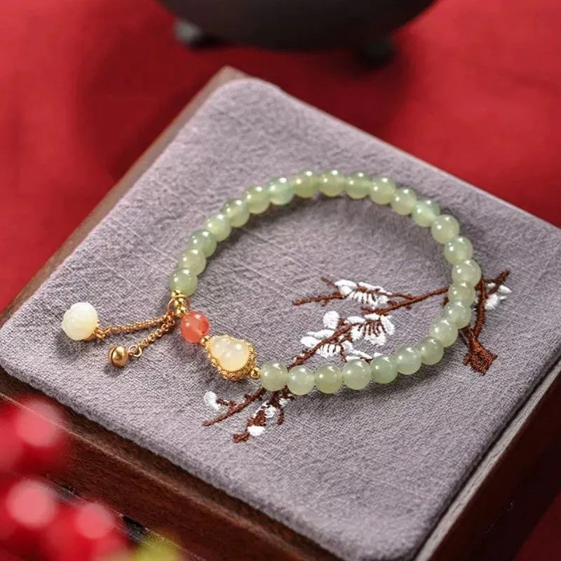 Qingshui jade bracelet with gold-plated details and a fu character on 6mm beads.