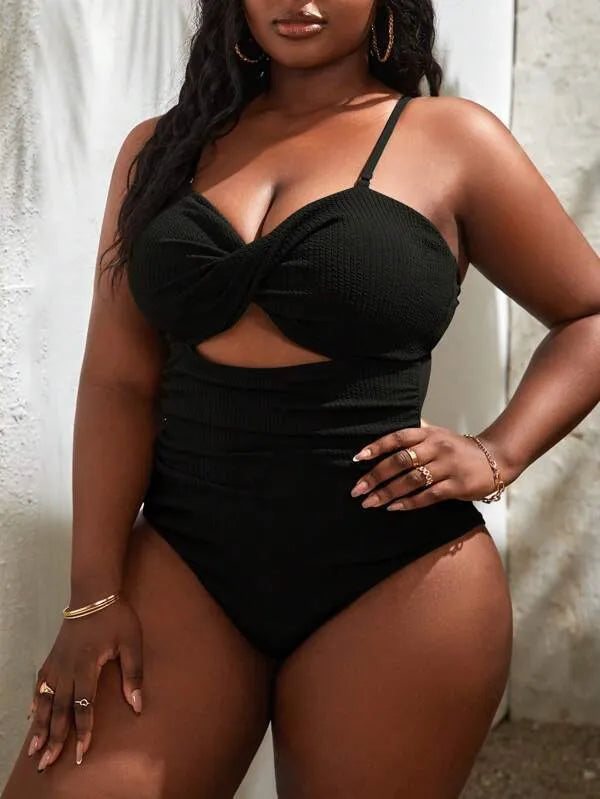 Plus size women's black slimming one-piece swimsuit with triangle sling design