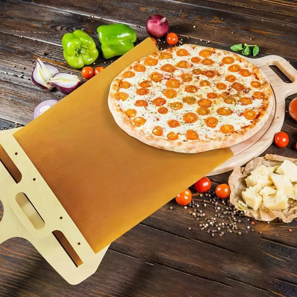 White food-grade PP plastic pizza transfer shovel with a hanging hole, shown on a kitchen counter.