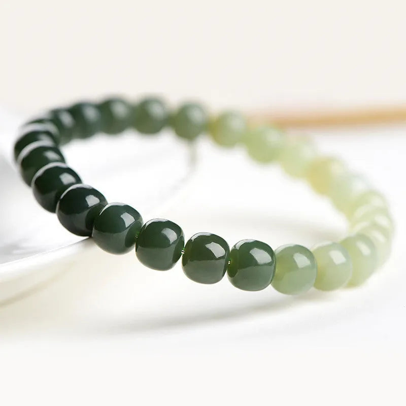 Natural Hetian jade bracelet with water gradient colour on polished beads.