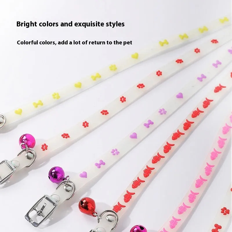Luminous cat collar with glowing effect, silicone chain, metal bell, in a paw print pattern design.