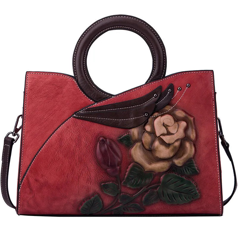 Handmade genuine leather women's handbag in contrasting colour with floral elements and zipper closure