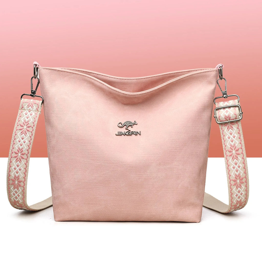 Soft grey PU crossbody bag with adjustable strap on mannequin
