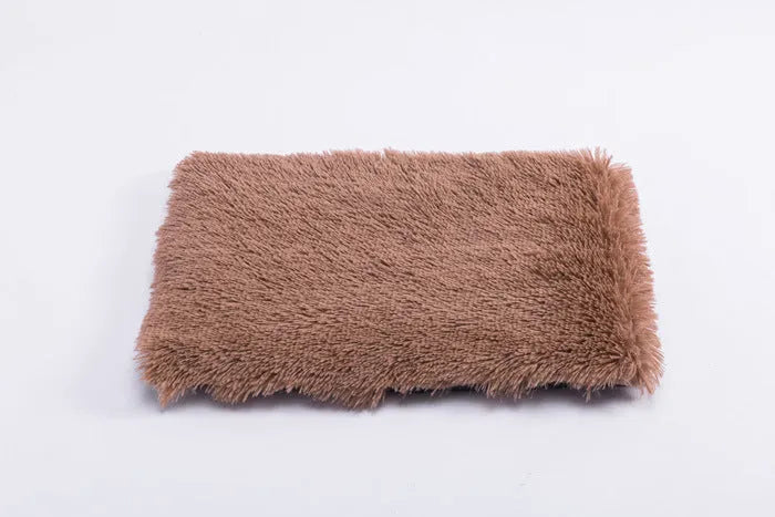 Plush pet nest with non-slip base, water-resistant material, available in multiple sizes and colours