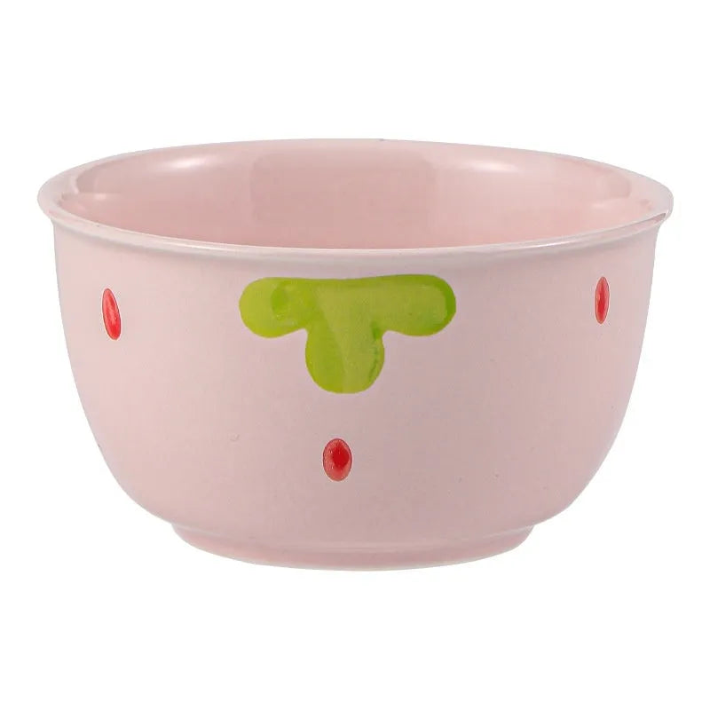 Porcelain dinnerware set with strawberry design showing bowls, plates, and a twist spoon.